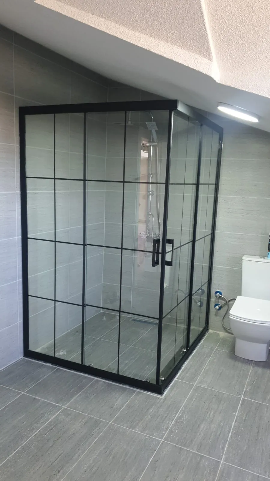 Bauhaus kareli desenli siyah profilli köşe duşakabin, gri banyo, geniş duş alanı